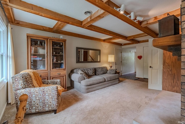 carpeted living area with beamed ceiling and coffered ceiling