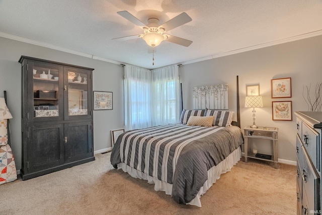 bedroom with crown molding, light colored carpet, a ceiling fan, and baseboards