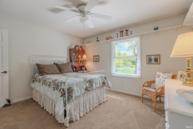 bedroom with light carpet, baseboards, and a ceiling fan