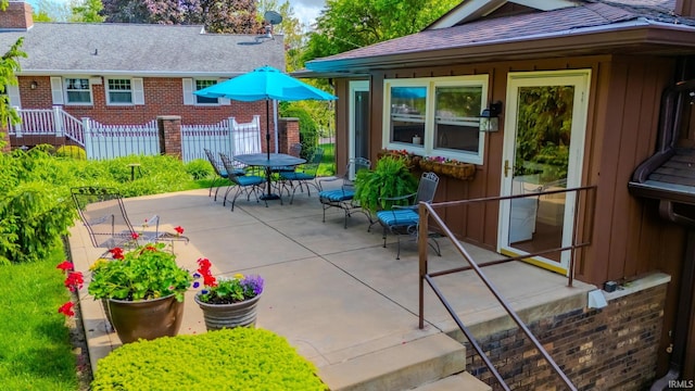 view of patio / terrace featuring fence and outdoor dining area