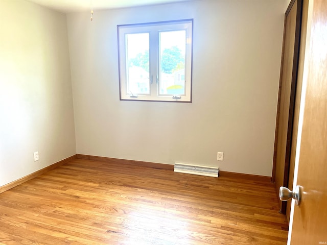 empty room featuring light wood-style floors and baseboards