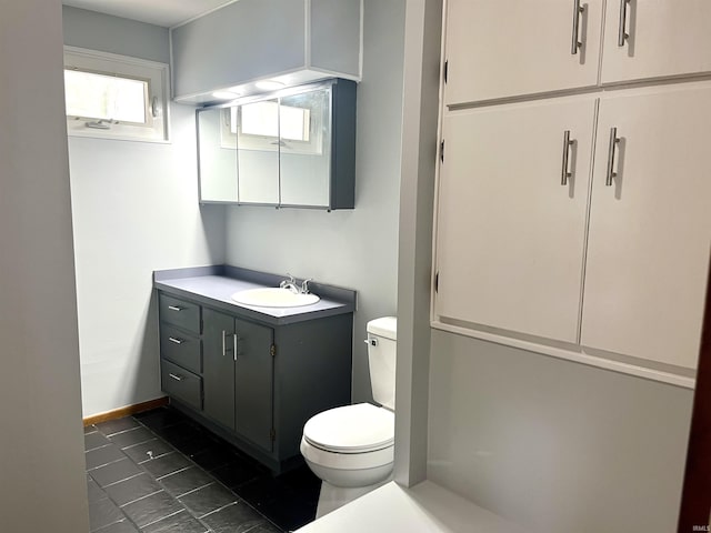 bathroom featuring toilet, vanity, and tile patterned floors