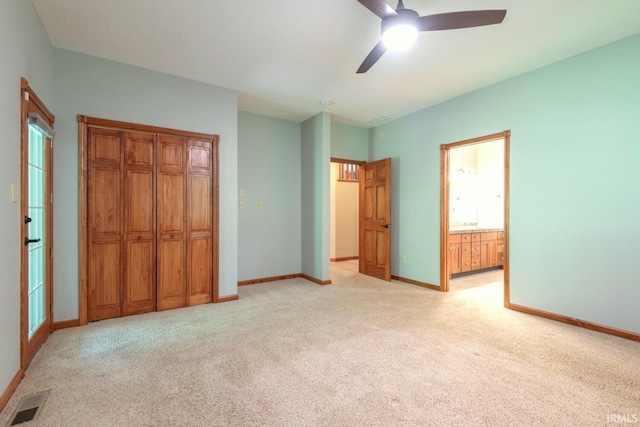 6015 E State Road 46, Bloomington, IN 47401 - unfurnished bedroom with light carpet, baseboards, and ensuite bathroom