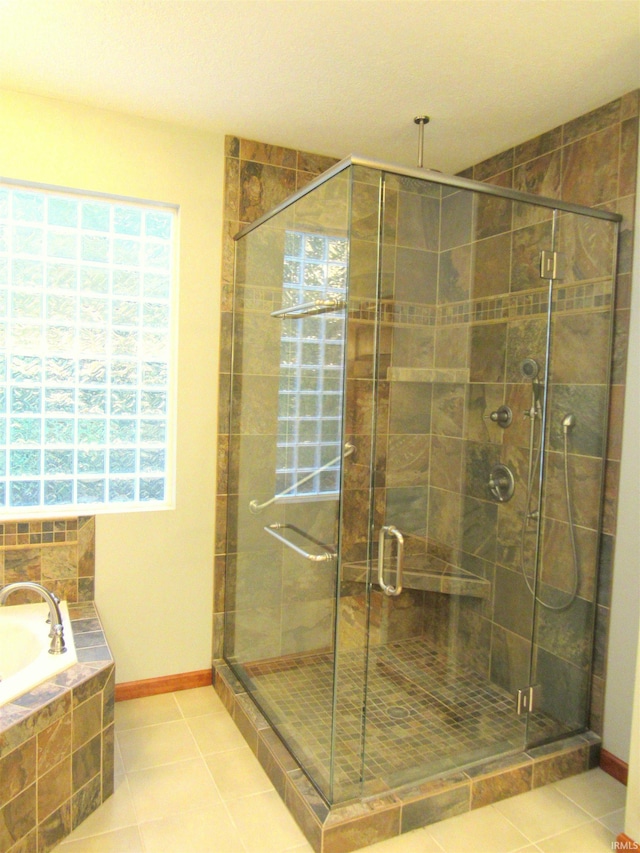 6015 E State Road 46, Bloomington, IN 47401 - full bath featuring healthy amount of natural light, a stall shower, a bath, and tile patterned floors
