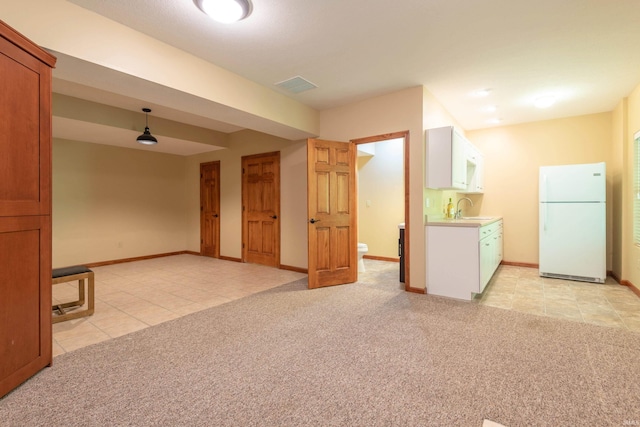 6015 E State Road 46, Bloomington, IN 47401 - unfurnished living room featuring a sink, light tile patterned flooring, light carpet, and baseboards