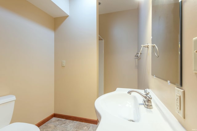6015 E State Road 46, Bloomington, IN 47401 - bathroom featuring a sink, baseboards, and toilet