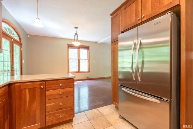 6015 E State Road 46, Bloomington, IN 47401 - kitchen with stainless steel refrigerator, brown cabinetry, plenty of natural light, and light countertops