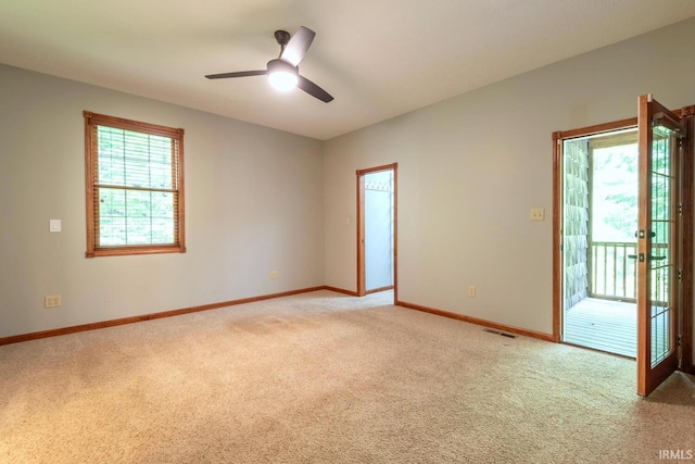6015 E State Road 46, Bloomington, IN 47401 - empty room featuring light colored carpet, baseboards, and a ceiling fan