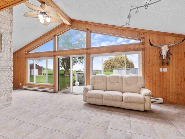 4038 Fahlsing Rd, Woodburn, IN 46797 - living area featuring wooden walls, a baseboard radiator, light tile patterned flooring, plenty of natural light, and a textured ceiling