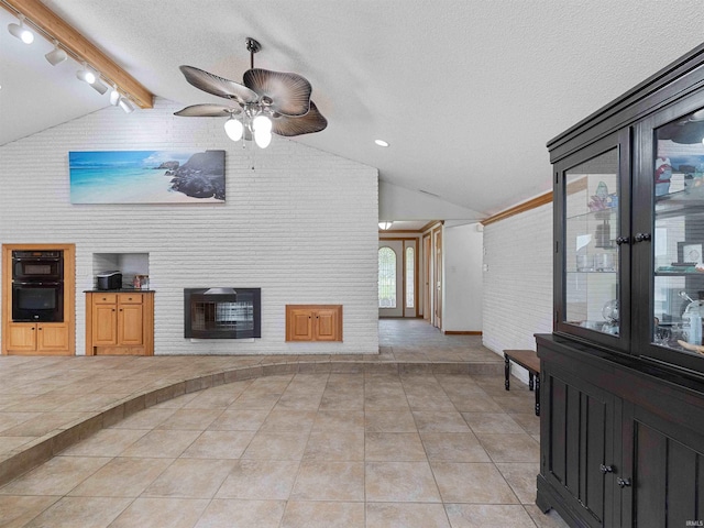 4038 Fahlsing Rd, Woodburn, IN 46797 - unfurnished living room with rail lighting, a fireplace, ceiling fan, baseboards, and light tile patterned floors