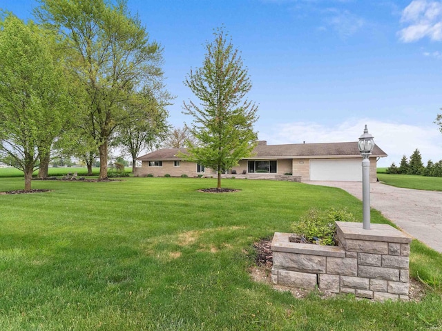 4038 Fahlsing Rd, Woodburn, IN 46797 - view of grassy yard featuring an attached garage and concrete driveway