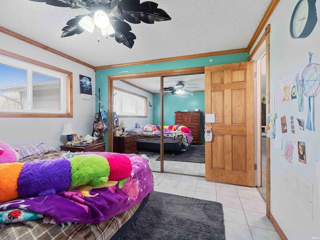 4038 Fahlsing Rd, Woodburn, IN 46797 - bedroom with light tile patterned flooring, ornamental molding, a closet, a textured ceiling, and a ceiling fan
