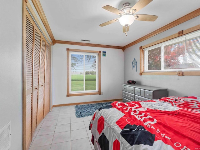 4038 Fahlsing Rd, Woodburn, IN 46797 - bedroom featuring multiple windows, light tile patterned floors, crown molding, baseboards, and a closet