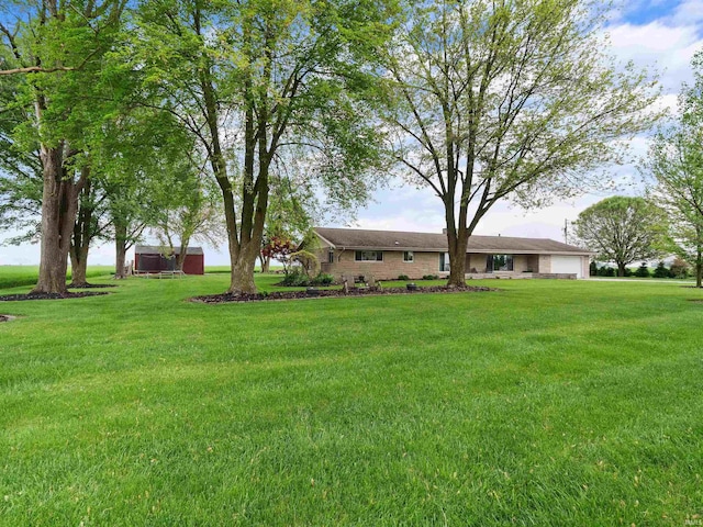 4038 Fahlsing Rd, Woodburn, IN 46797 - view of green lawn featuring an attached garage