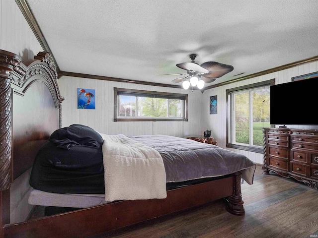 4038 Fahlsing Rd, Woodburn, IN 46797 - bedroom featuring ornamental molding, a textured ceiling, wood finished floors, ceiling fan, and wooden walls