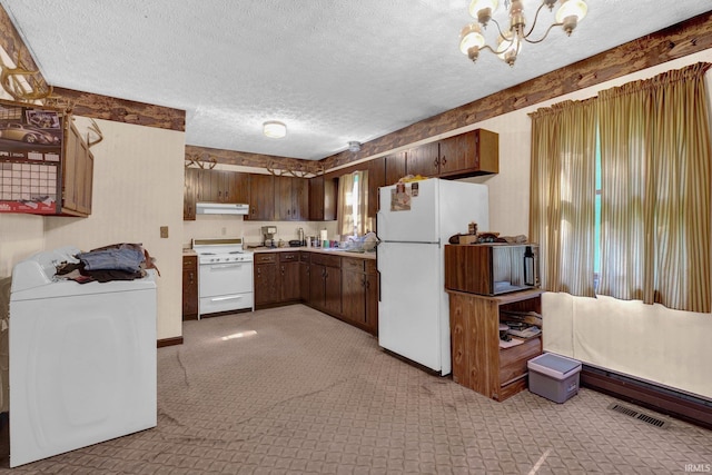 kitchen with washer / clothes dryer, white appliances, under cabinet range hood, light countertops, and a chandelier