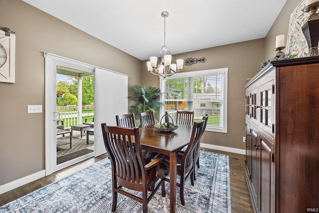dining space featuring a chandelier, baseboards, and dark wood-type flooring