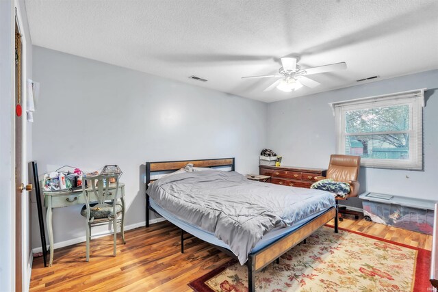 9126 Redfield Dr, Fort Wayne, IN 46819 - bedroom with wood finished floors, a textured ceiling, and a ceiling fan
