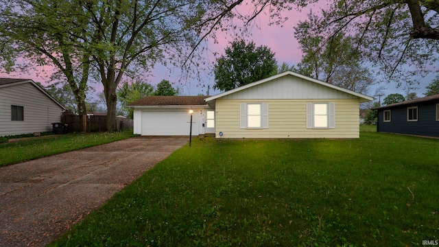 2219 Drake Dr, Fort Wayne, IN 46819 - view of front of home featuring driveway, a yard, and a garage