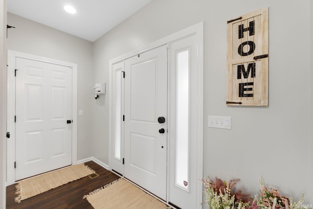 entryway featuring dark wood-style floors and baseboards