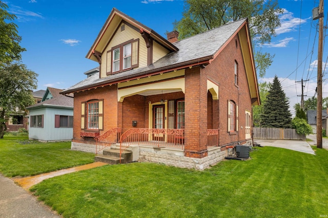 view of front of home featuring a porch, brick siding, a chimney, and central air condition unit