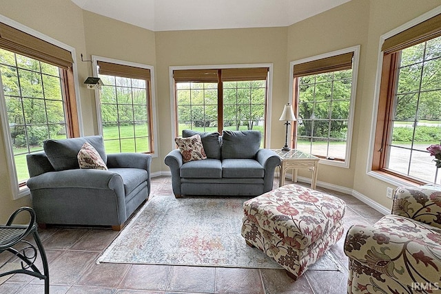 living area with baseboards and tile patterned floors
