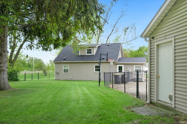 rear view of property featuring a shingled roof