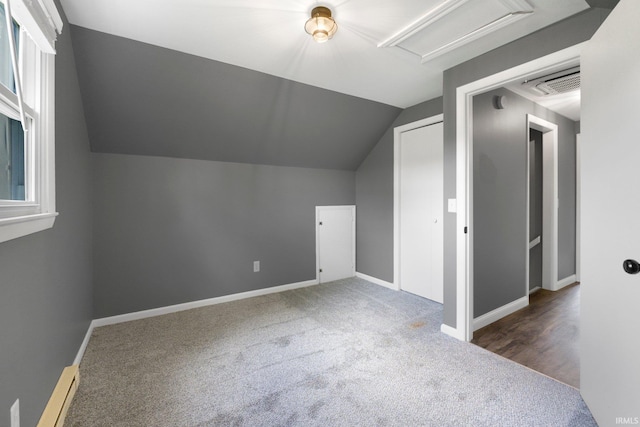 bonus room featuring carpet floors, lofted ceiling, a baseboard radiator, baseboards, and attic access