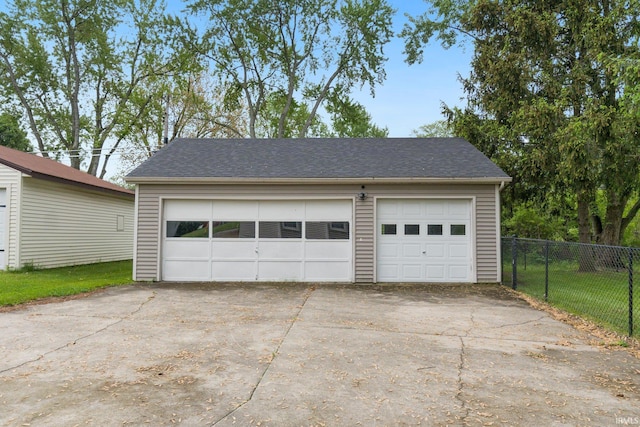 detached garage featuring fence