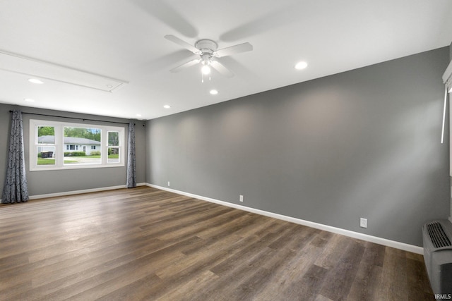 empty room featuring attic access, dark wood-style floors, ceiling fan, baseboards, and recessed lighting