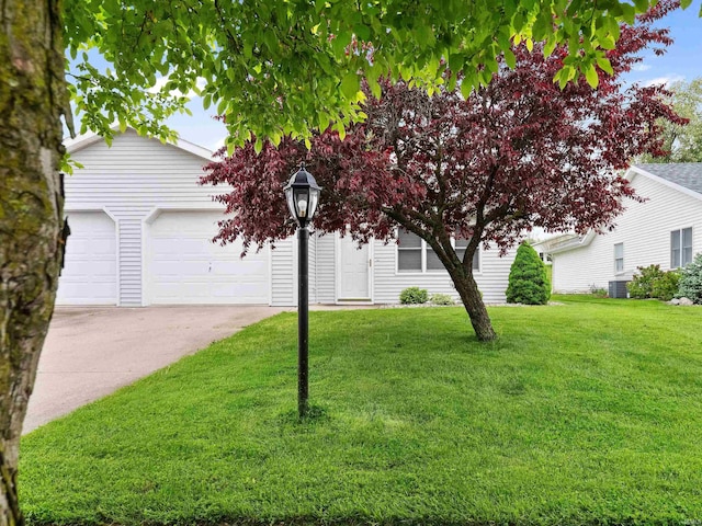 obstructed view of property with cooling unit, a garage, concrete driveway, and a front lawn