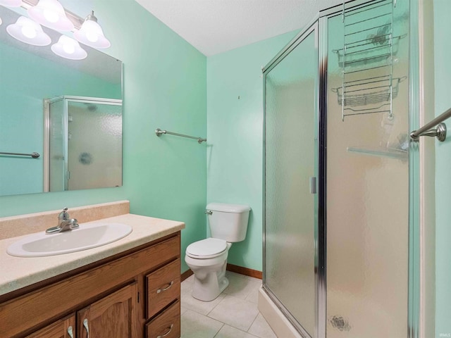 full bathroom with a stall shower, tile patterned flooring, toilet, and vanity