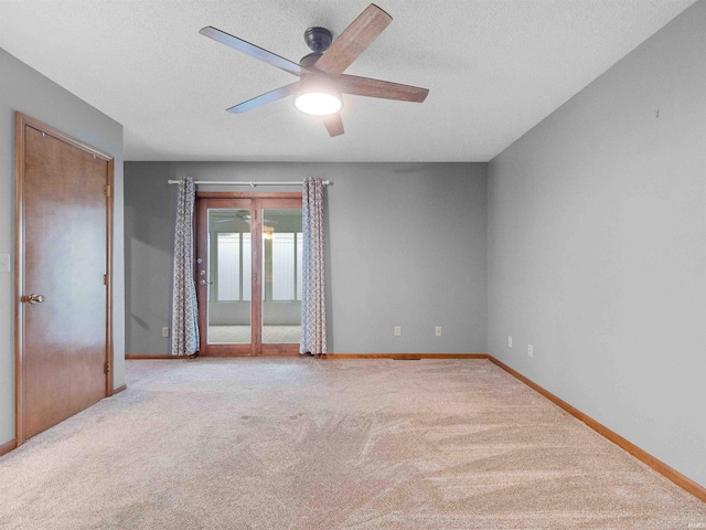 unfurnished room featuring a ceiling fan, carpet flooring, baseboards, and a textured ceiling