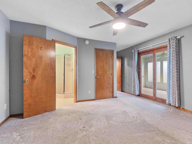 unfurnished bedroom with carpet, access to exterior, baseboards, a textured ceiling, and ensuite bathroom