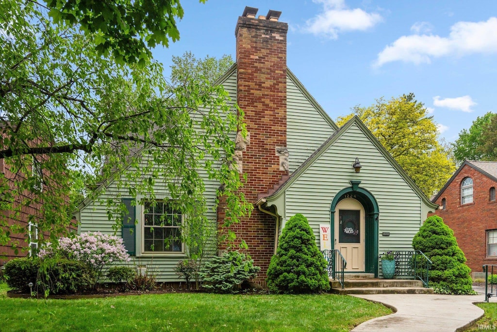 1229 Maxine Dr, Fort Wayne, IN 46807 - tudor house with a chimney and a front lawn