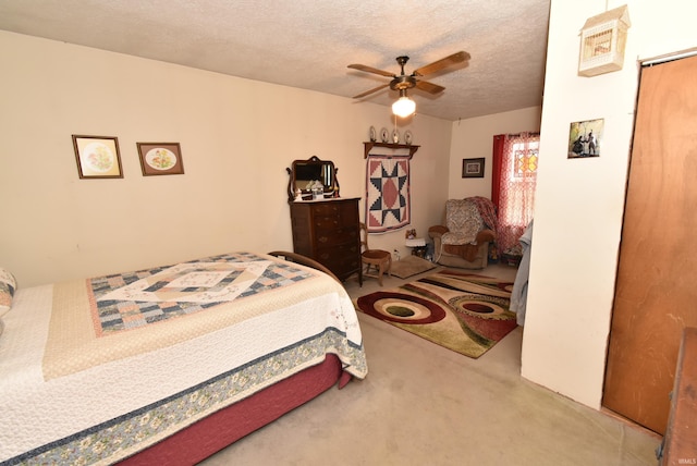 carpeted bedroom with a textured ceiling and a ceiling fan