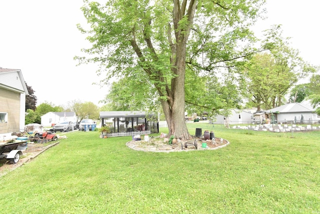 view of yard featuring a carport and a sunroom