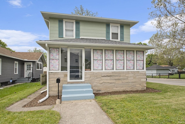 241 E Fairview Ave, South Bend, IN 46614 - american foursquare style home with stone siding, entry steps, a shingled roof, and a front lawn