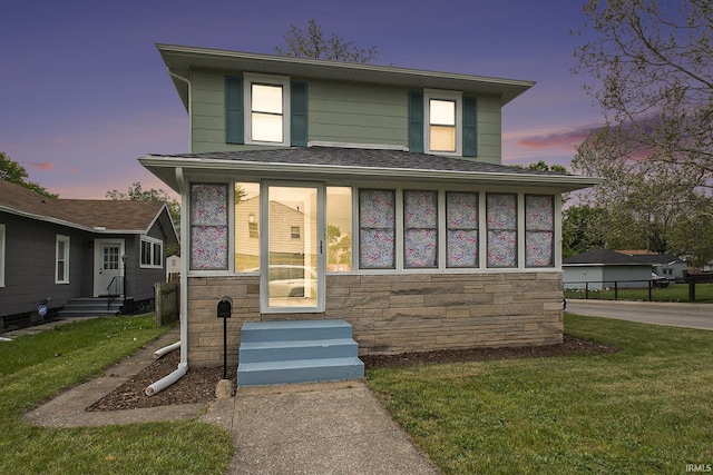 241 E Fairview Ave, South Bend, IN 46614 - traditional style home featuring entry steps, stone siding, a lawn, and roof with shingles