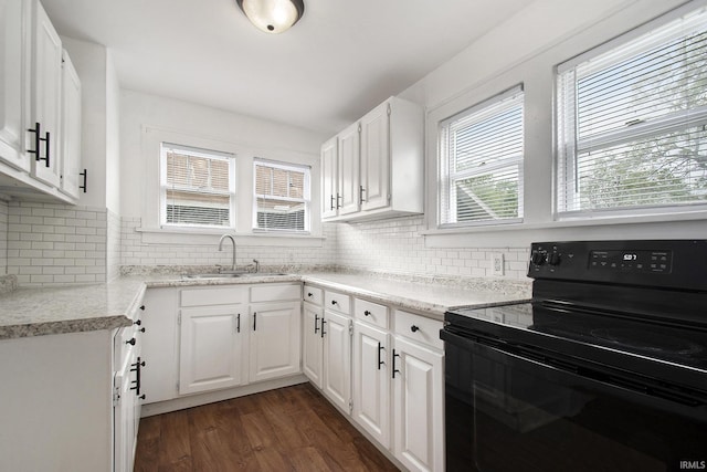 241 E Fairview Ave, South Bend, IN 46614 - kitchen featuring electric range, a sink, dark wood-type flooring, and white cabinets