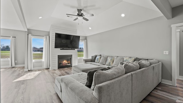 422 Westward Dr, Butler, IN 46721 - living area featuring vaulted ceiling, a ceiling fan, healthy amount of natural light, baseboards, and wood finished floors
