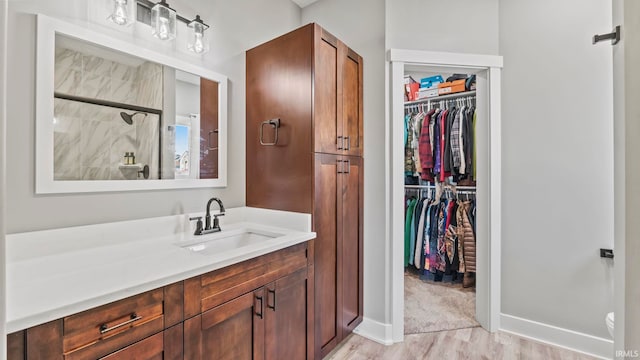 422 Westward Dr, Butler, IN 46721 - full bath with wood finished floors, a spacious closet, vanity, a shower, and baseboards
