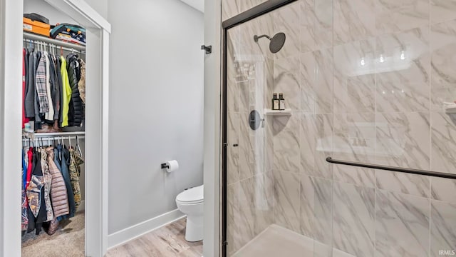 422 Westward Dr, Butler, IN 46721 - full bath featuring a walk in closet, a stall shower, toilet, and baseboards