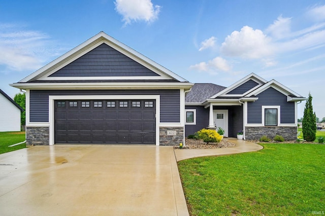 422 Westward Dr, Butler, IN 46721 - craftsman-style home with stone siding, a front lawn, driveway, and an attached garage