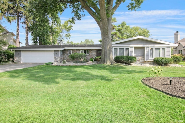 22147 Sunset Ln, Elkhart, IN 46516 - ranch-style home with stone siding, a garage, driveway, and a front lawn