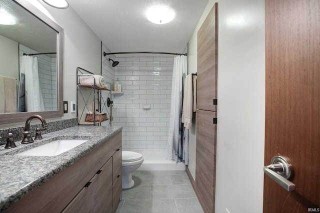 22147 Sunset Ln, Elkhart, IN 46516 - full bathroom featuring vanity, a stall shower, toilet, a textured ceiling, and tile patterned floors