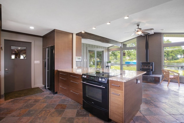 22147 Sunset Ln, Elkhart, IN 46516 - kitchen featuring black appliances, stone tile flooring, a wood stove, modern cabinets, and vaulted ceiling