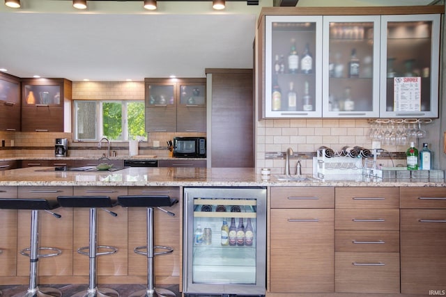 22147 Sunset Ln, Elkhart, IN 46516 - kitchen featuring beverage cooler, a sink, modern cabinets, and decorative backsplash