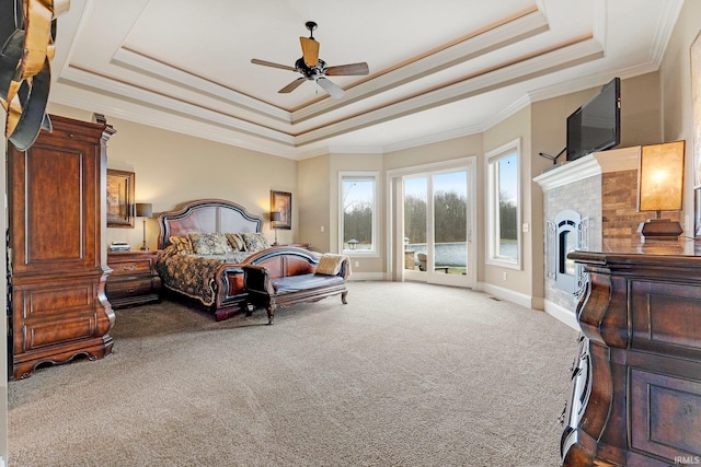 6482 Hollopeter Rd, Leo, IN 46765 - carpeted bedroom with a tray ceiling, a fireplace, crown molding, baseboards, and ceiling fan