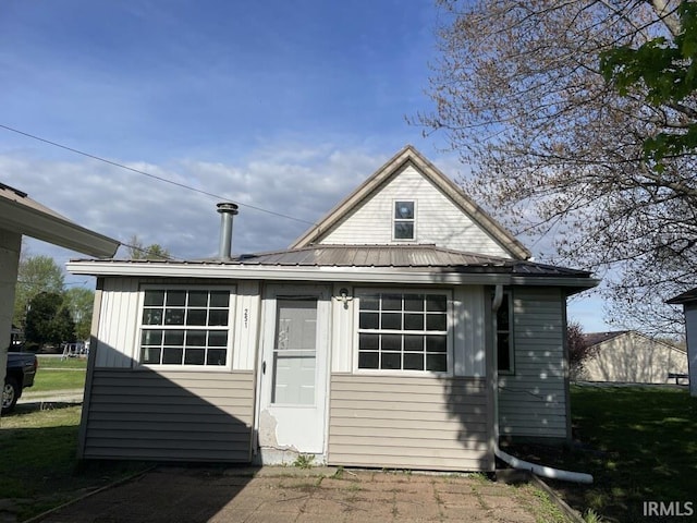 251 N Snowden St, Andrews, IN 46702 - rear view of property with metal roof and board and batten siding